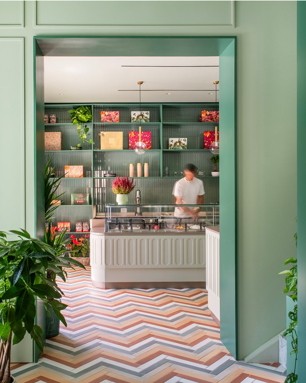 Bar Galatea pastry counter with pastel green interiors and geometric herringbone floor