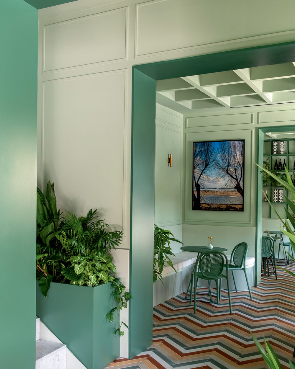 Interior passage with green walls, integrated plants and geometric flooring at Bar Galatea