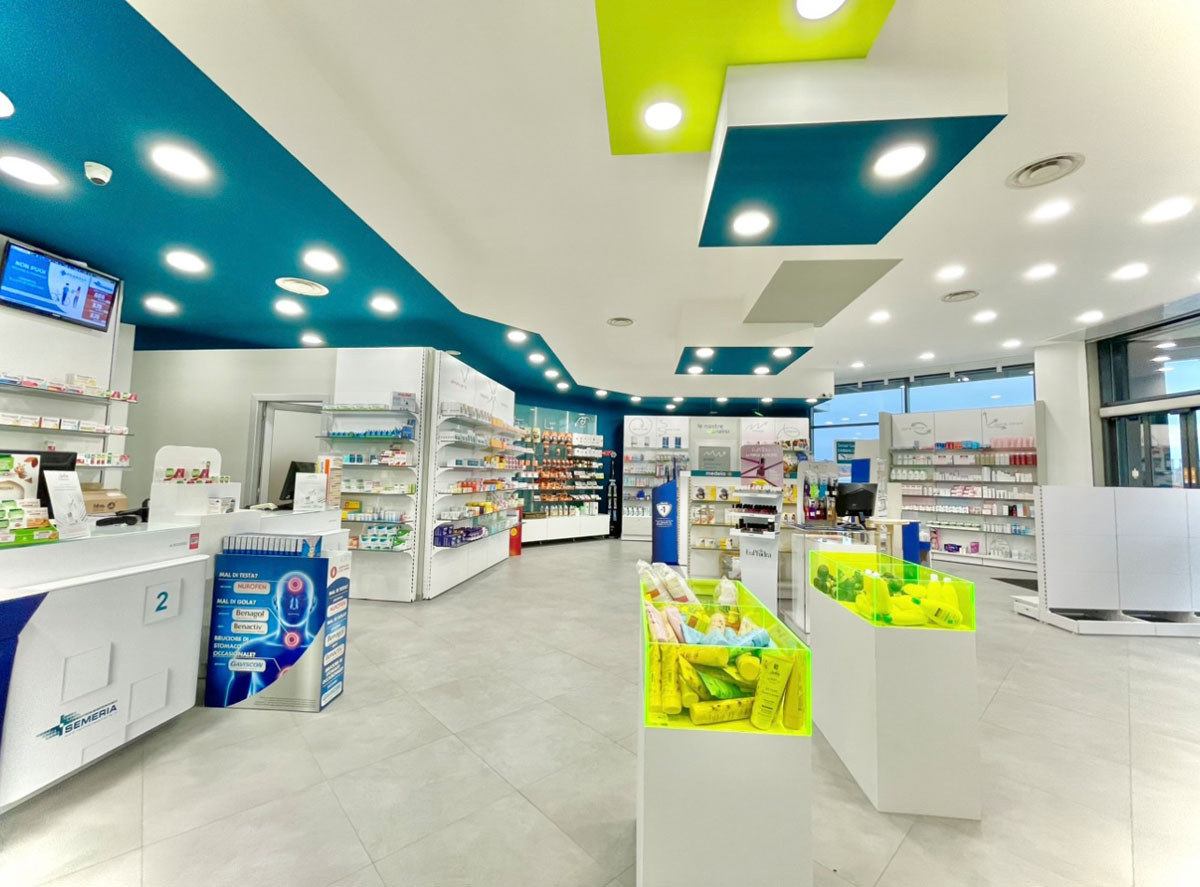 Pharmacy interiors with illuminated display layout and organized customer pathways