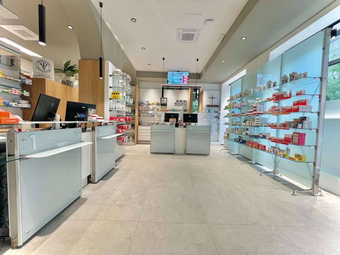 Pharmacy retail area with modular shelving and integrated communication systems