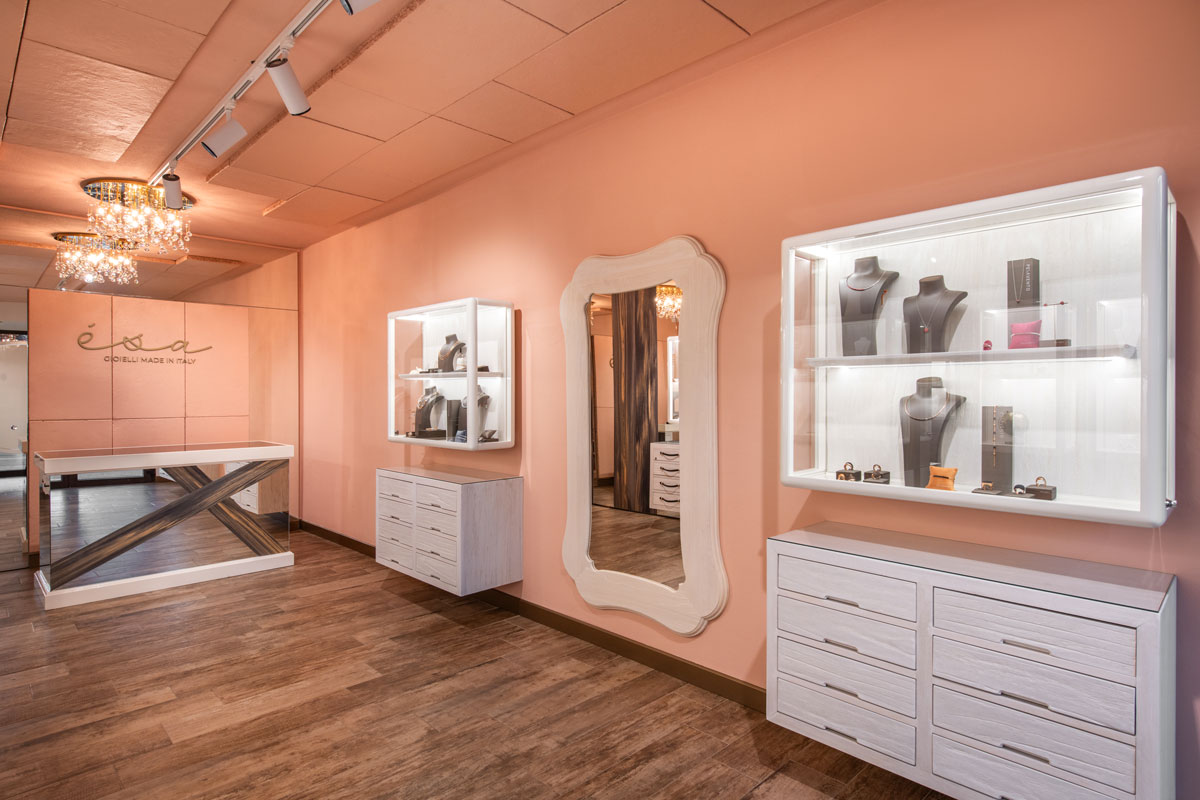 Interior of Esa Jewelry Store in Livigno with illuminated showcases, light-toned furnishings and peach-colored walls