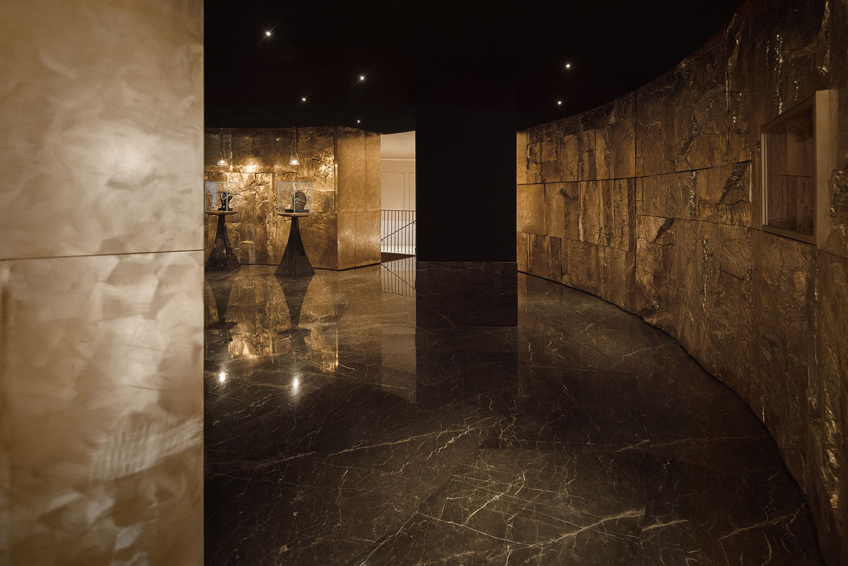 Interior of the jewelry flagship store with mineral surfaces and marble display podiums