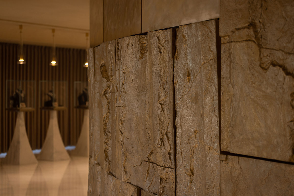 Exhibition path inside the Lao Feng Xiang flagship with stone, copper and jewelry displays
