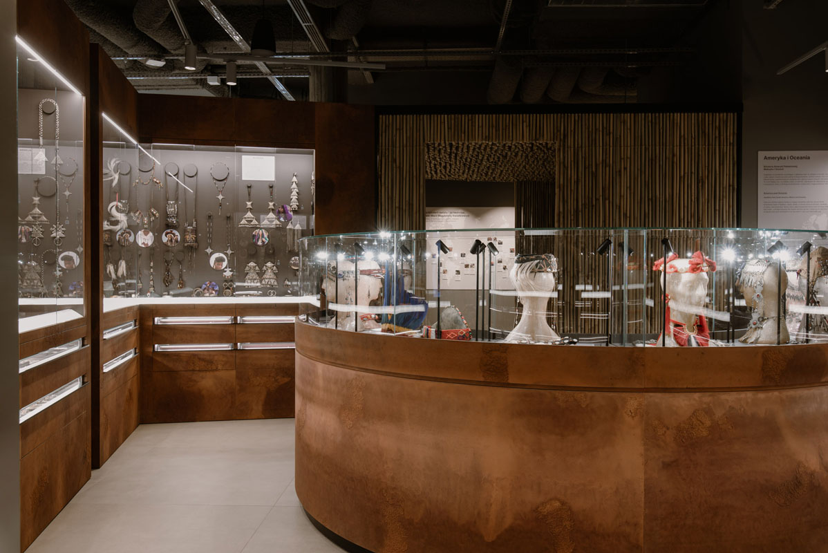 Exhibition layout with warm materials and integrated lighting at the MoJA Jewelry Museum