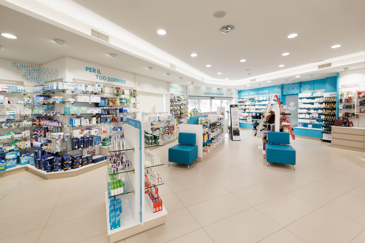 Pharmacy interior with open layout, central display units, white furniture and turquoise details for product areas