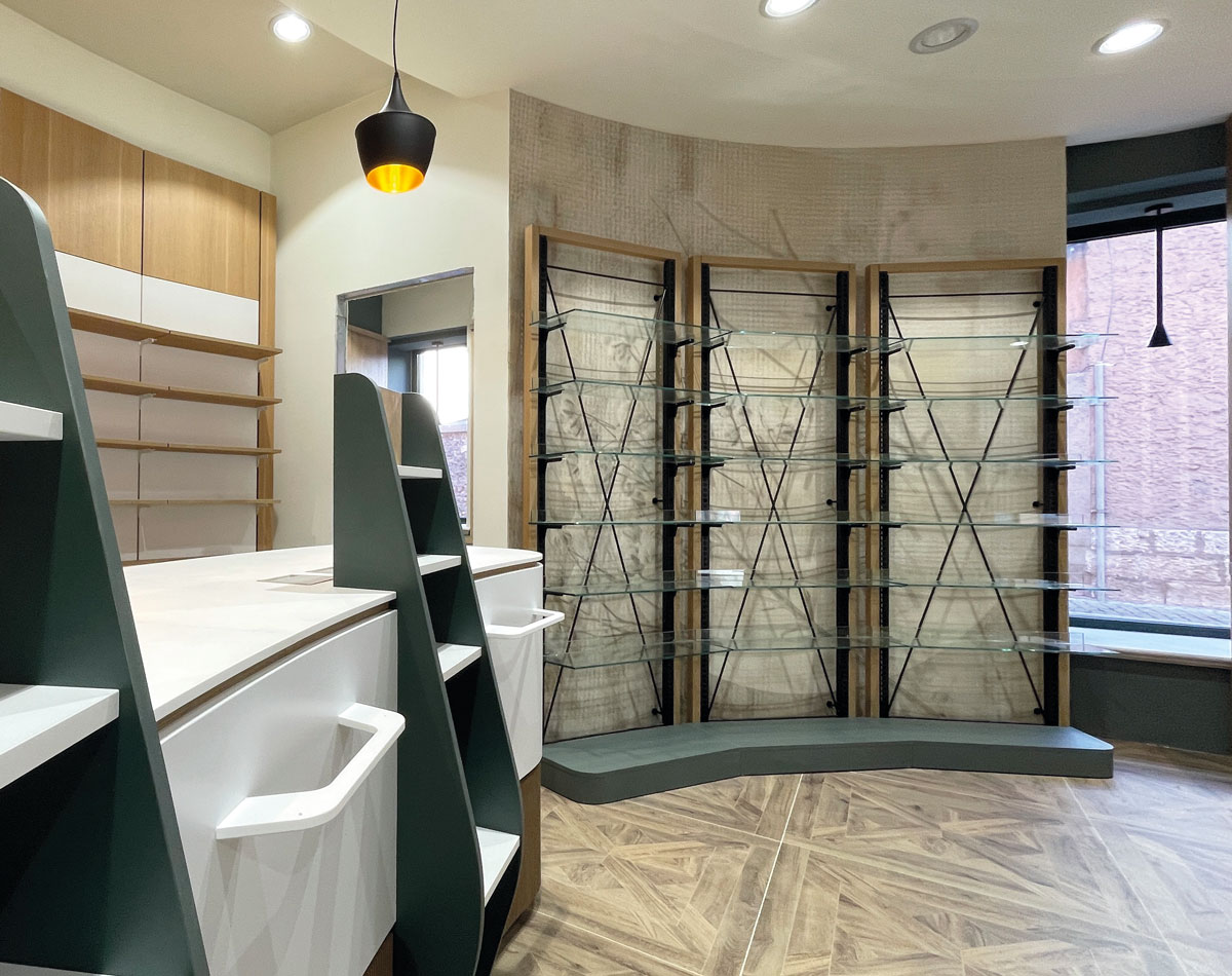 Retail space with glass and wood displays and geometric wood-effect flooring