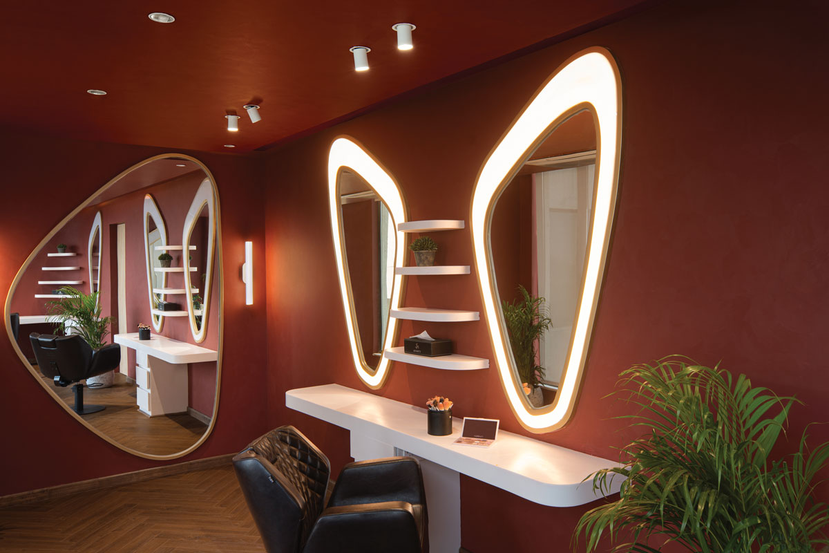 Private treatment room at Affinity Salon featuring illuminated mirrors, bespoke furnishings and softly finished surfaces.