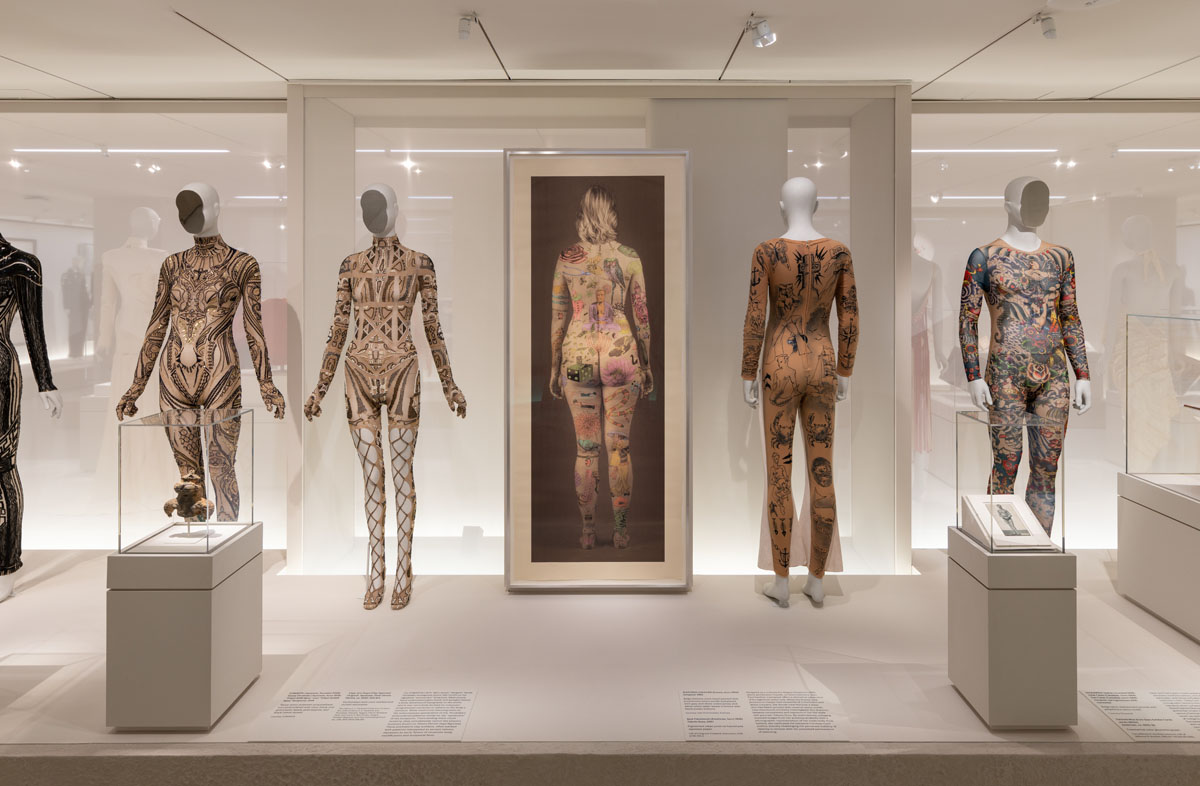 Decorated body garments displayed on Bonaveri mannequins alongside artworks in the Costume Art exhibition.