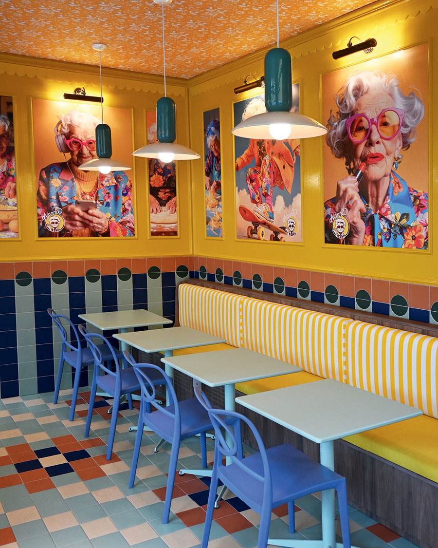 Dining room of Da Nonna in CityLife with striped banquettes, pastel-coloured seating and decorated walls