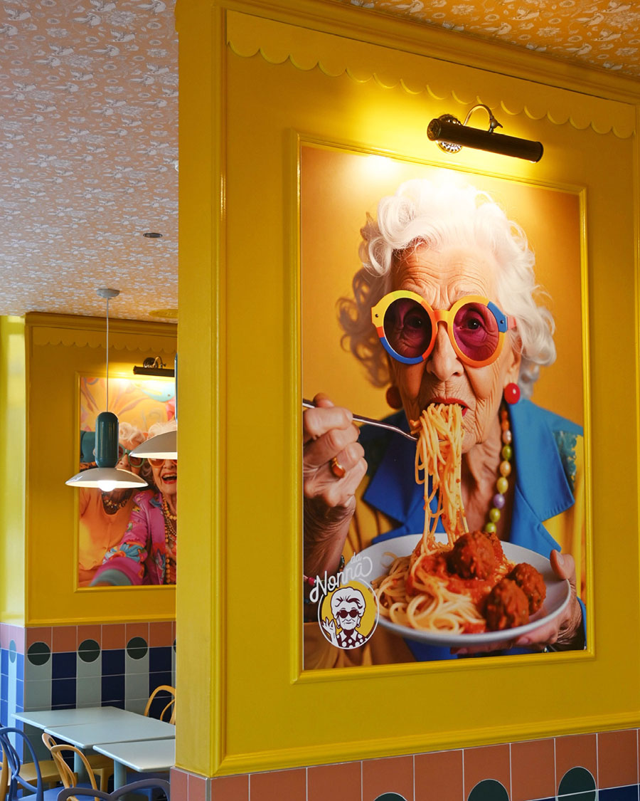 Decorative portrait of the nonna inside Da Nonna restaurant in Milan with yellow walls and retro-inspired lighting