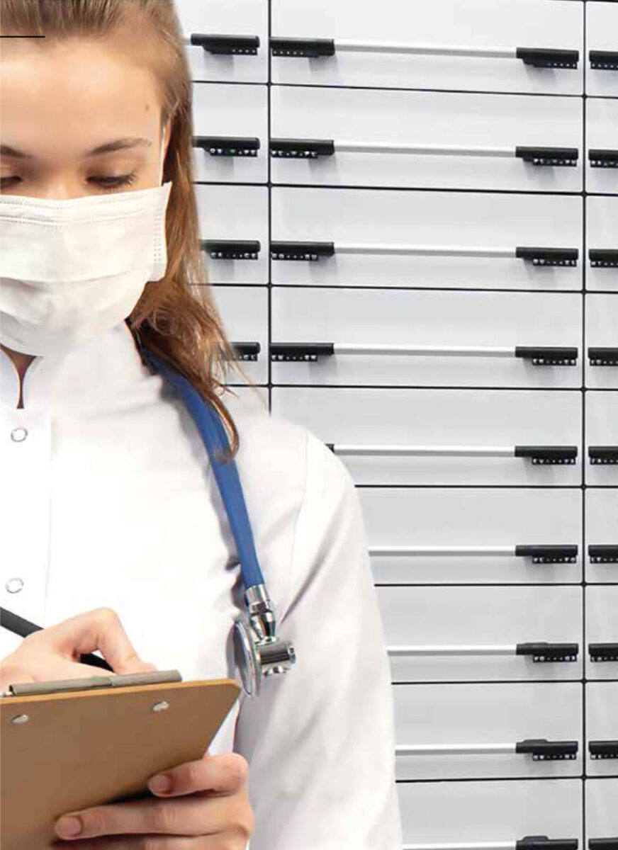 Healthcare worker in front of ICAS modular drawer units for medicine management in hospitals and healthcare facilities