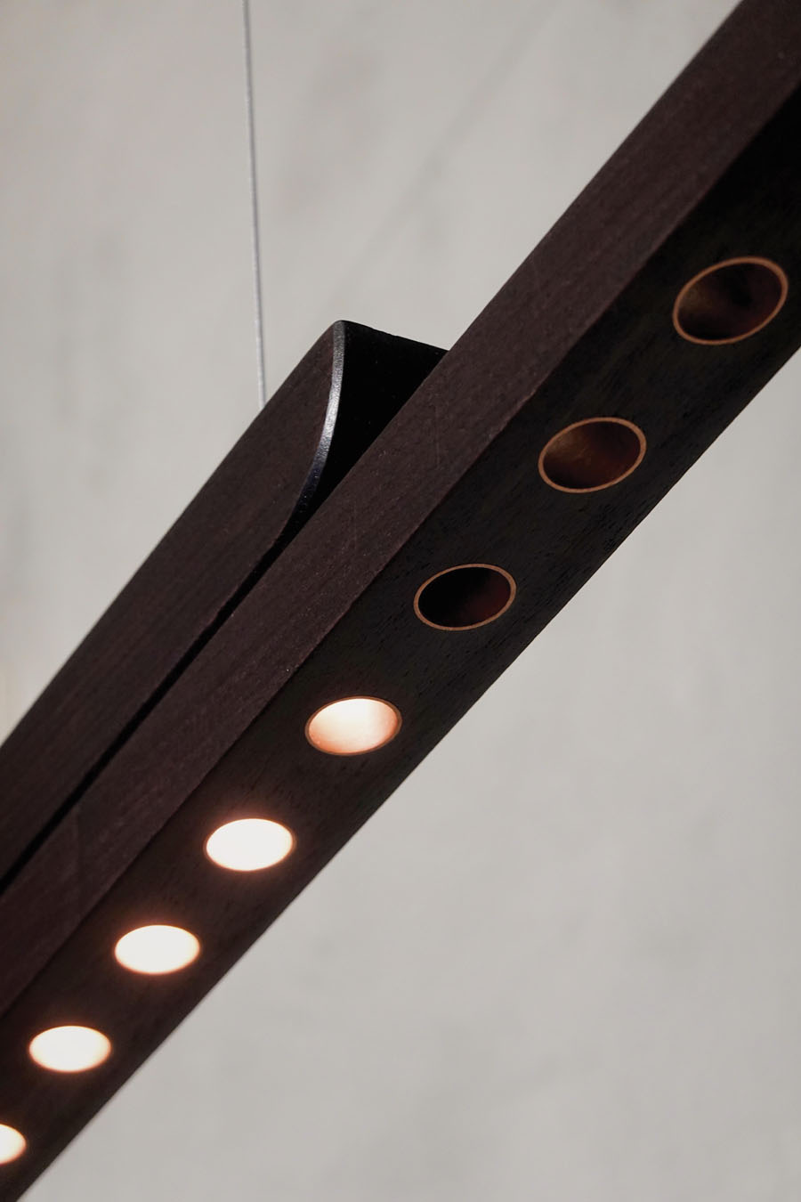 Detail of the Moono lamp in walnut with integrated LED lighting