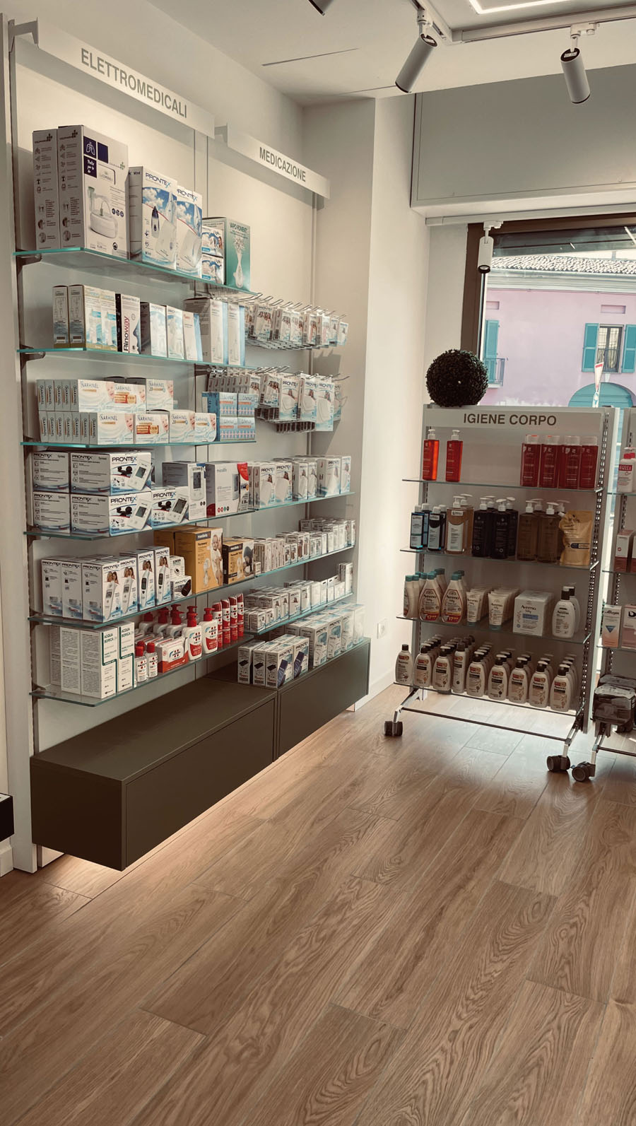 Pharmacy sales counter with transparent protective panels and suspended lighting