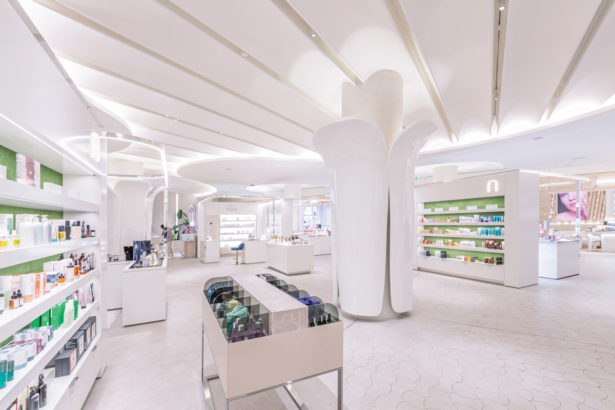 Beauty retail environment at Rennaï Beauty Hall with illuminated display systems, open circulation paths and organic architectural forms