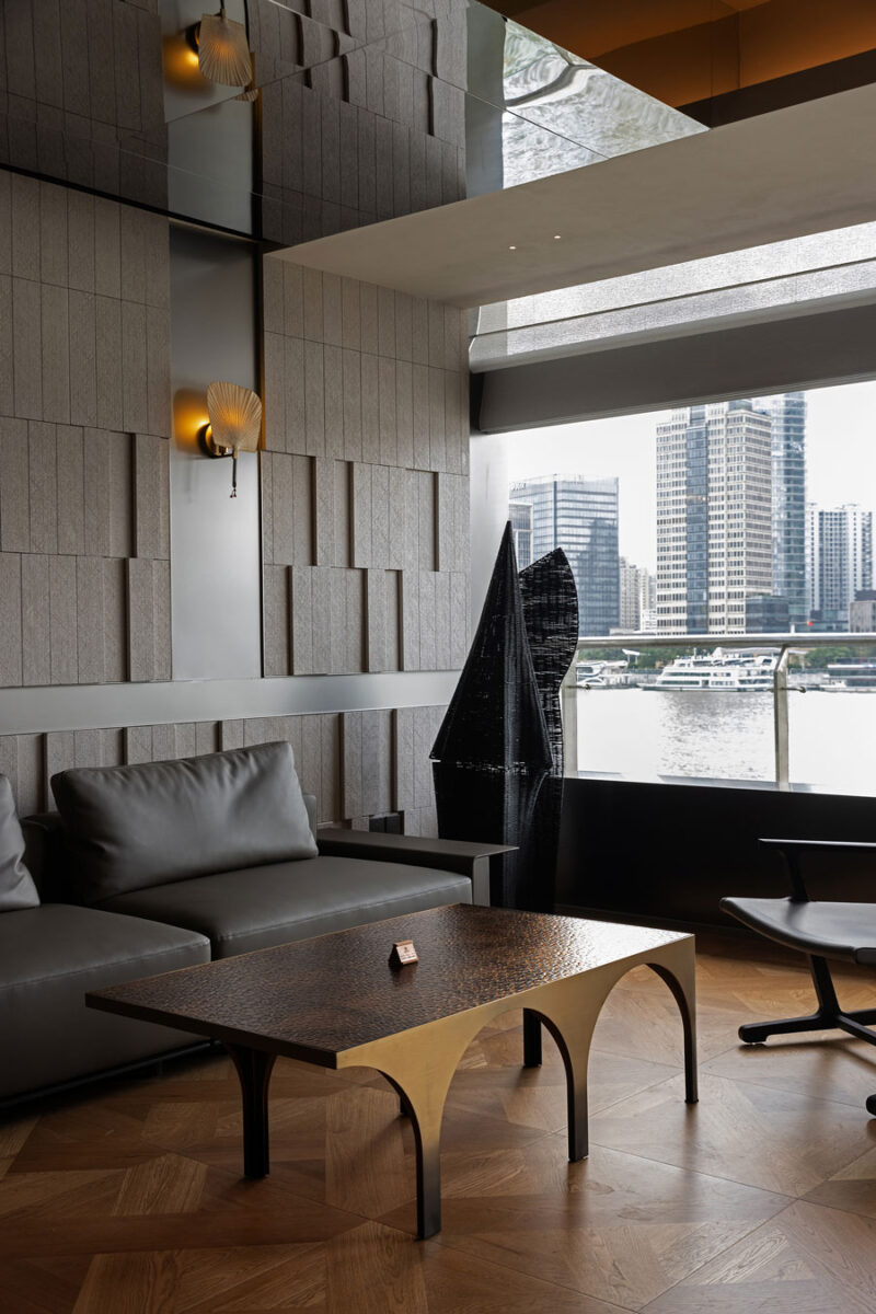 Lounge area at Shu Pavilion Restaurant featuring textured finishes, contemporary furnishings and river views