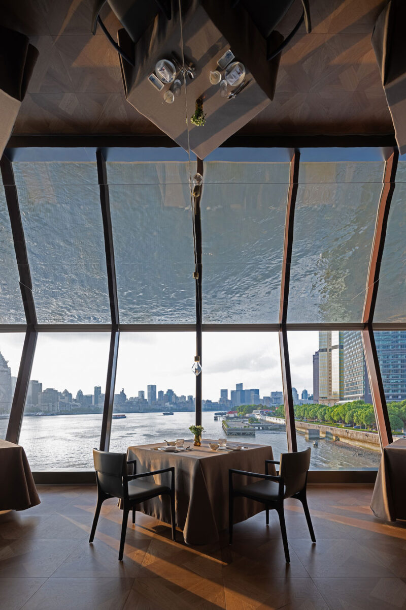 Dining table at Shu Pavilion Restaurant overlooking the Huangpu River through panoramic glazing
