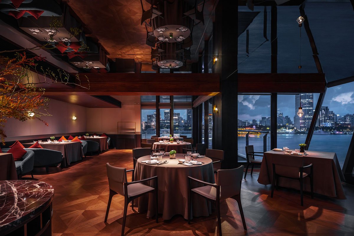 Entrance area of Shu Pavilion Restaurant with full-height wine display and Sichuan ingredient showcase