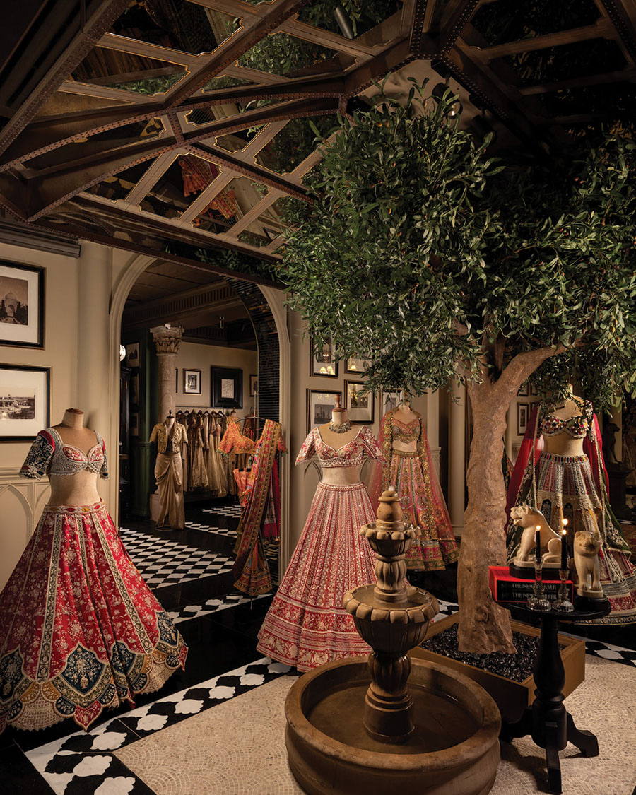 Gazal Gupta flagship display area with scenic tree, central fountain and couture garments.