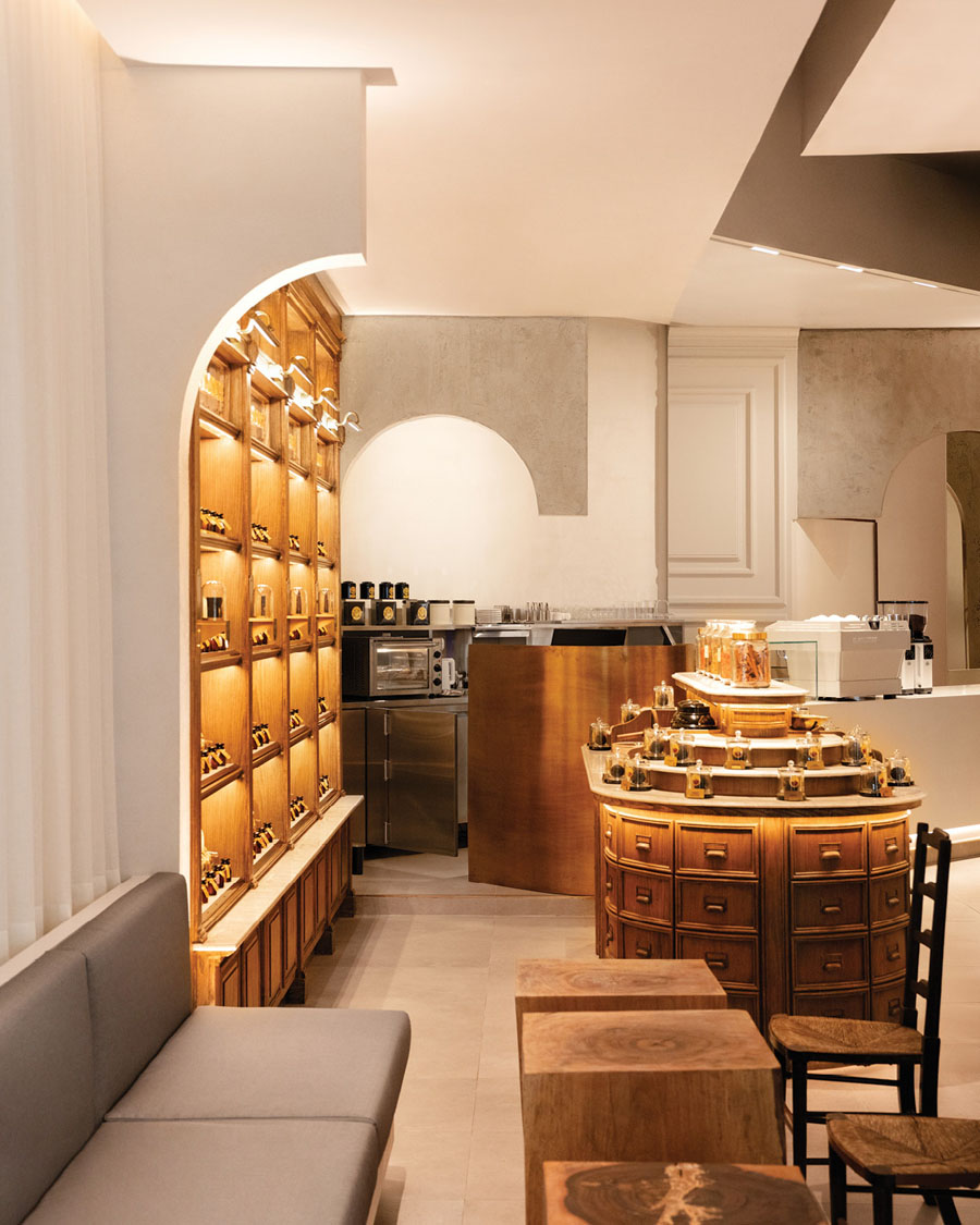 Hospitality area at Karmakamet with wooden seating and an integrated retail layout