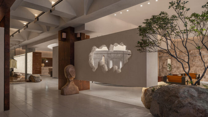Ingresso dello showroom Hé progettato da LubanEra•Design con apertura scultorea nel volume sospeso, pietra naturale e percorso espositivo