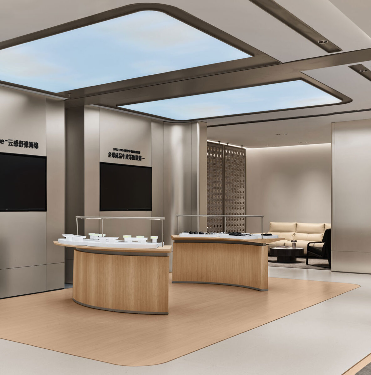 Technology area of the KUKA | JOY Living & Dining Showroom with wood display islands, information panels, illuminated ceiling surfaces and open circulation.