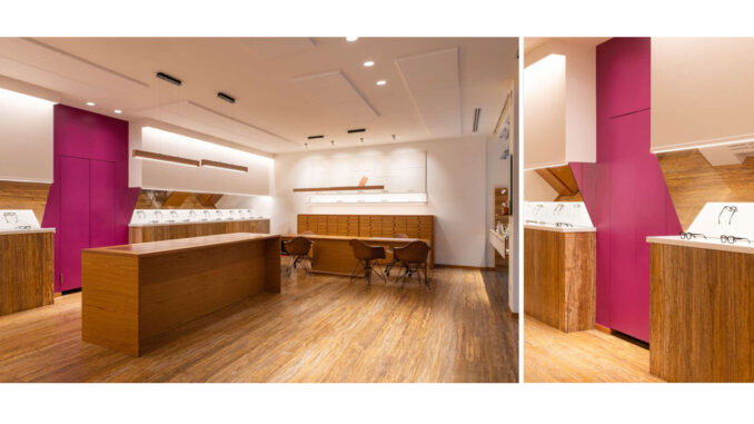 Interno del negozio Ottica Adami dopo il restyling: arredi recuperati, layout contemporaneo e porta porpora come elemento identitario.