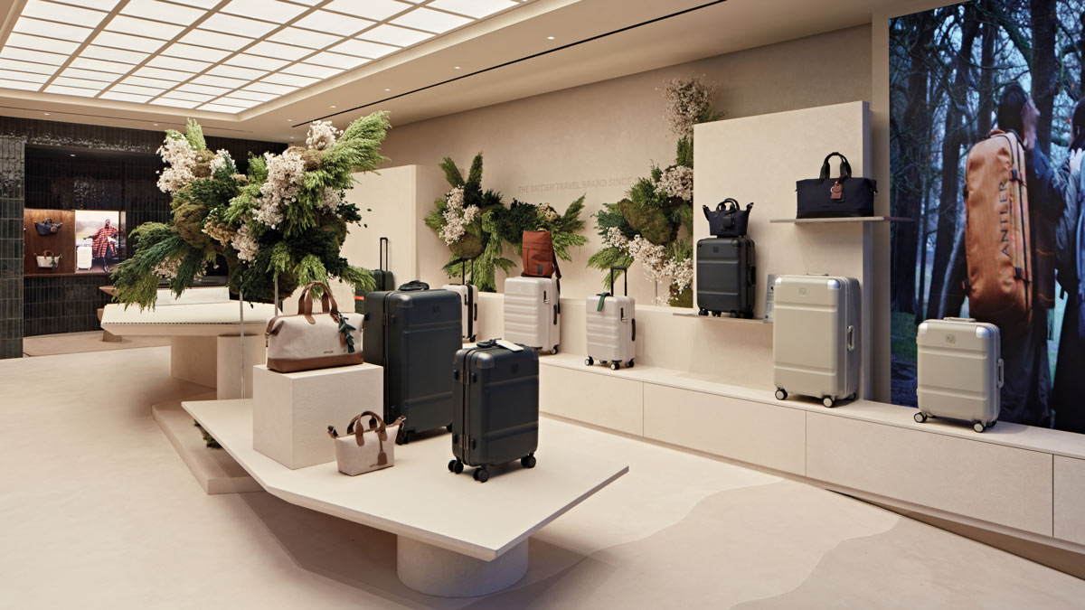 Interior of the Antler Regent Street flagship store in London with luggage, displays and botanical installations