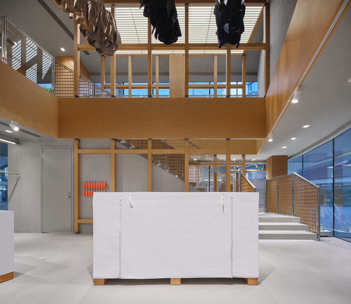 DESCENTE flagship interior in Beijing with timber structure, staircase and double-height space