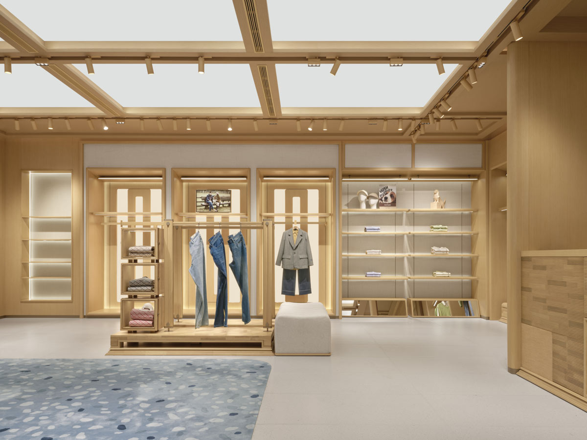 Interior of the Hush Puppies flagship store in Shanghai with a modular luminous ceiling and wooden display walls