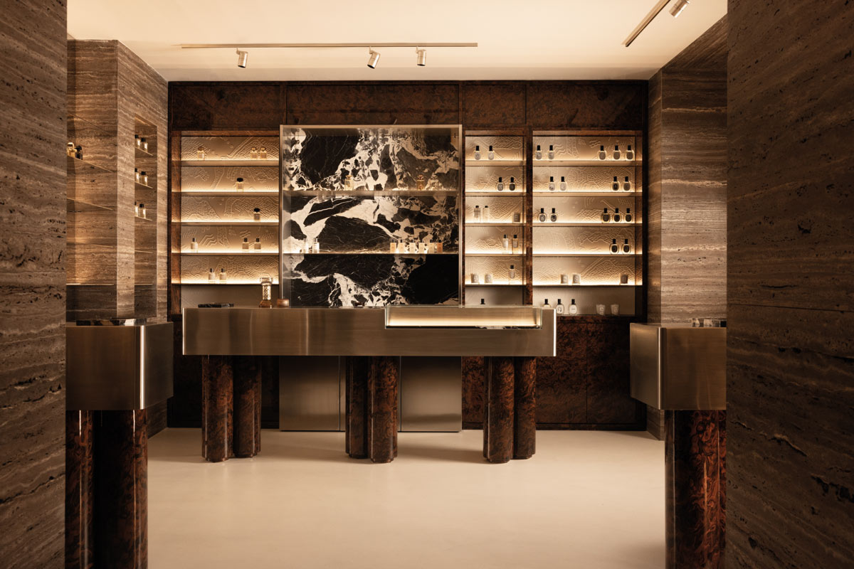 Jolie boutique interior in Naples with steel and burl wood displays