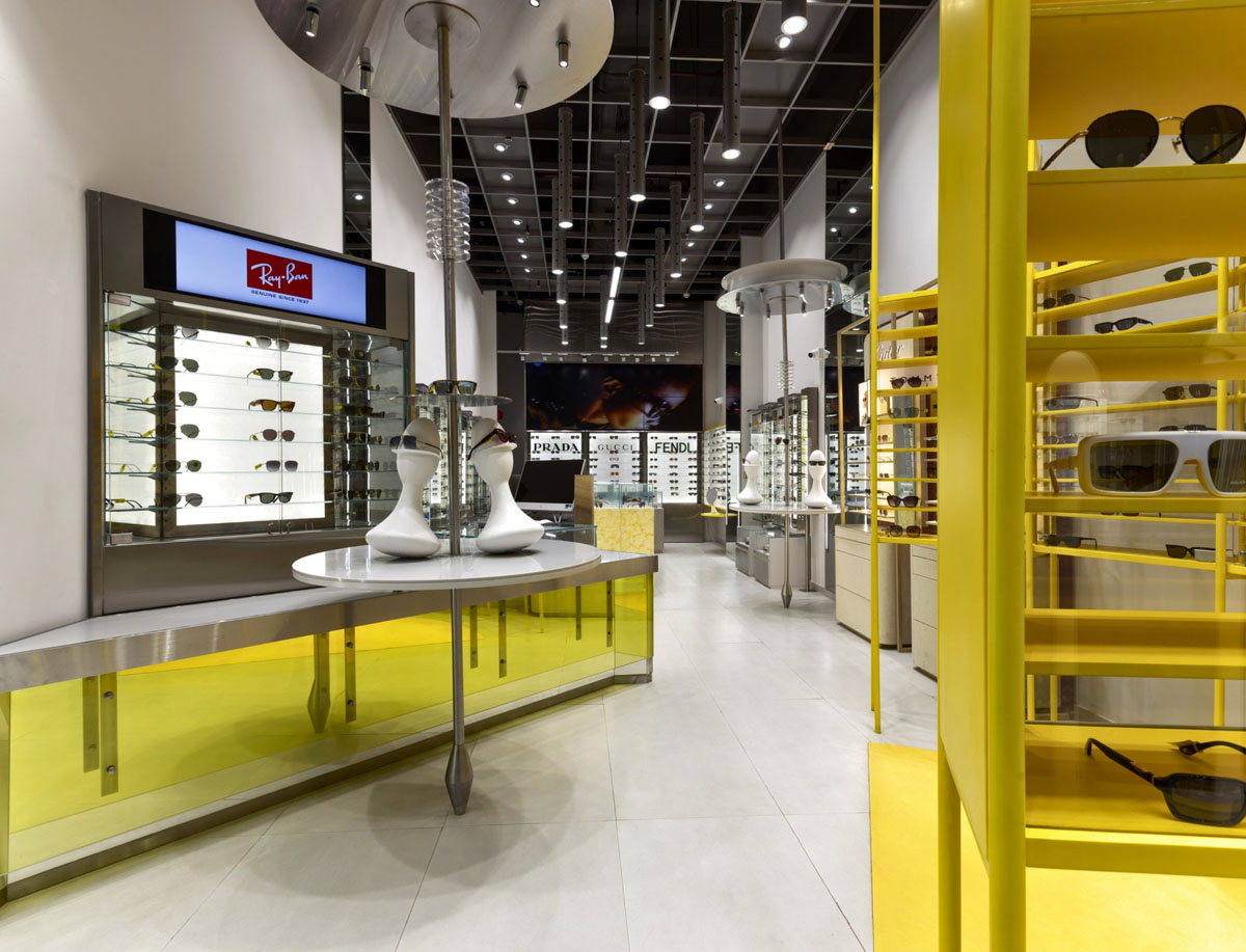 OPIQ interior with yellow displays, eyewear showcases and technical lighting