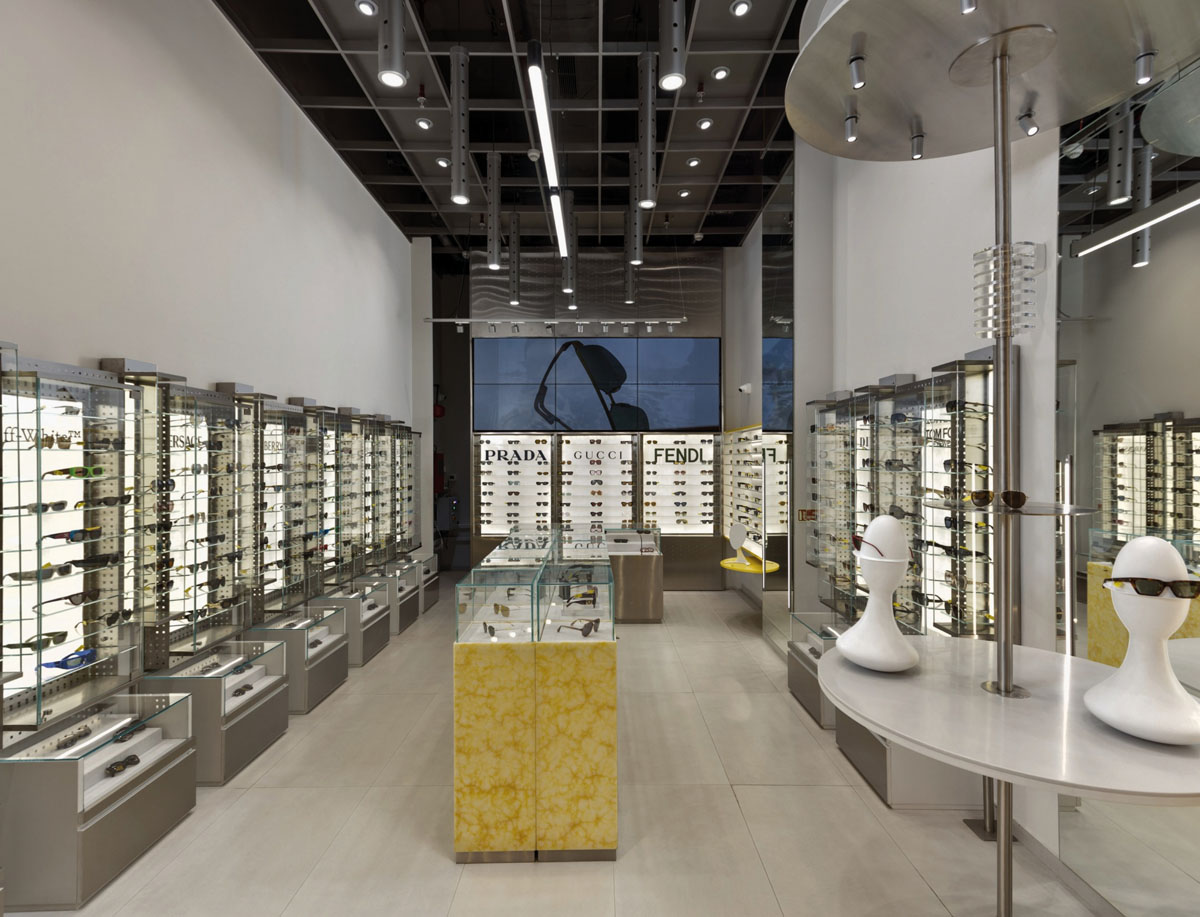 OPIQ optical store with illuminated showcases and wall-mounted eyewear displays