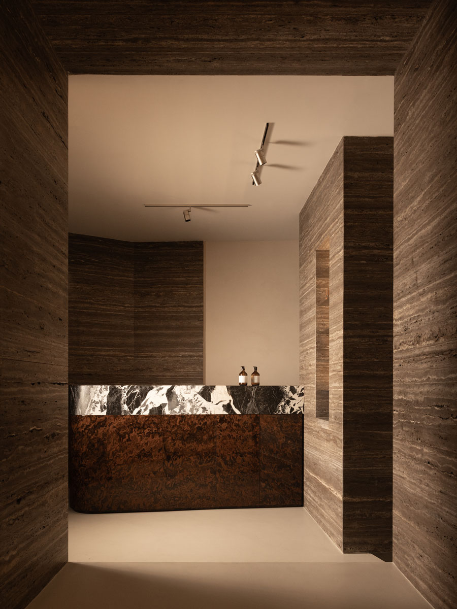 Jolie boutique display detail with travertine and burl wood