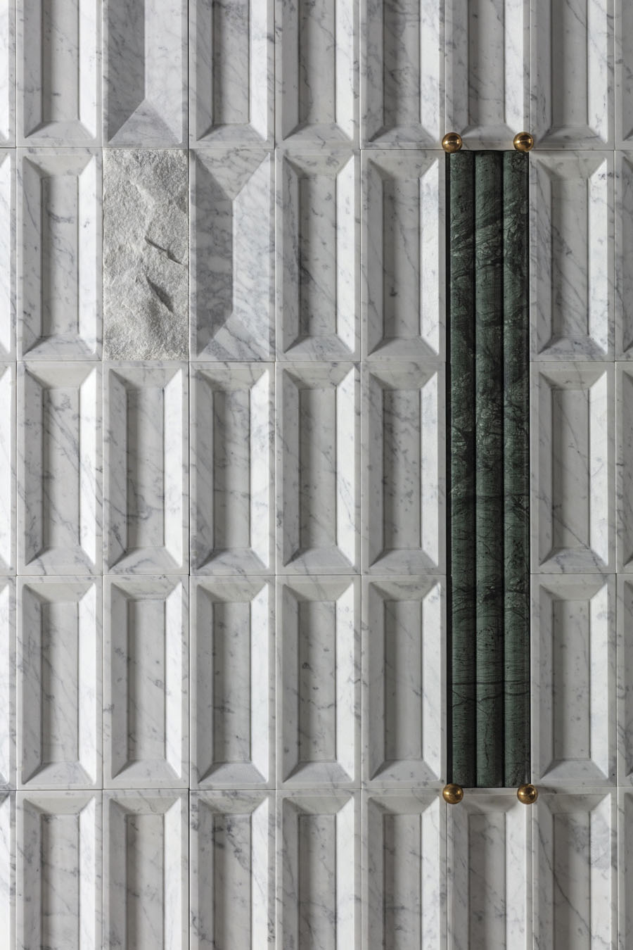 Detail of Lithea Windows of Light with sculpted geometric reliefs and green stone insert