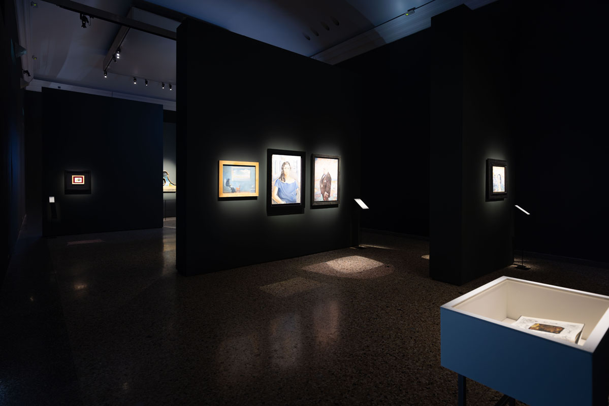 Dark walls and focused lighting at the Dalí and Fashion exhibition in Milan