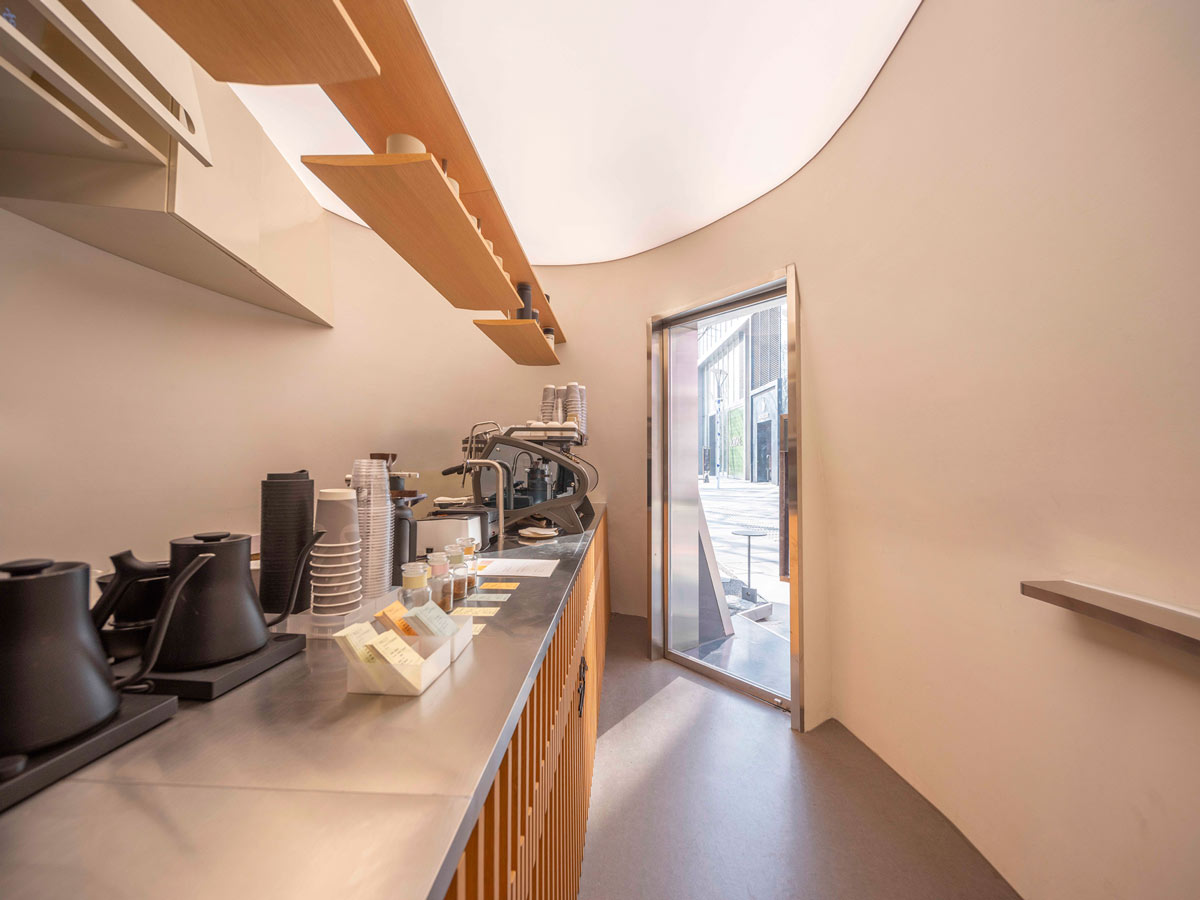 Interior of the Kurasu Pop-Up with its linear counter and coffee preparation area