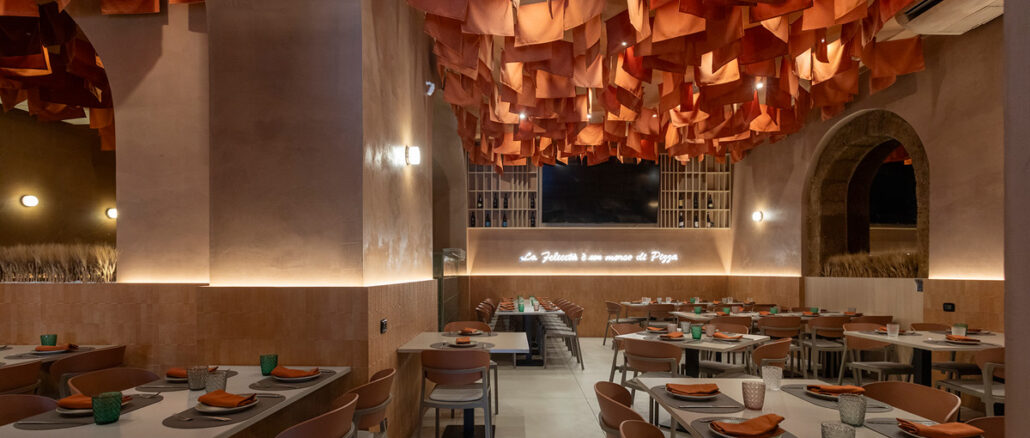Sala della pizzeria Due Archi a Gela con soffitto tessile sospeso, archi e arredi in rovere sbiancato