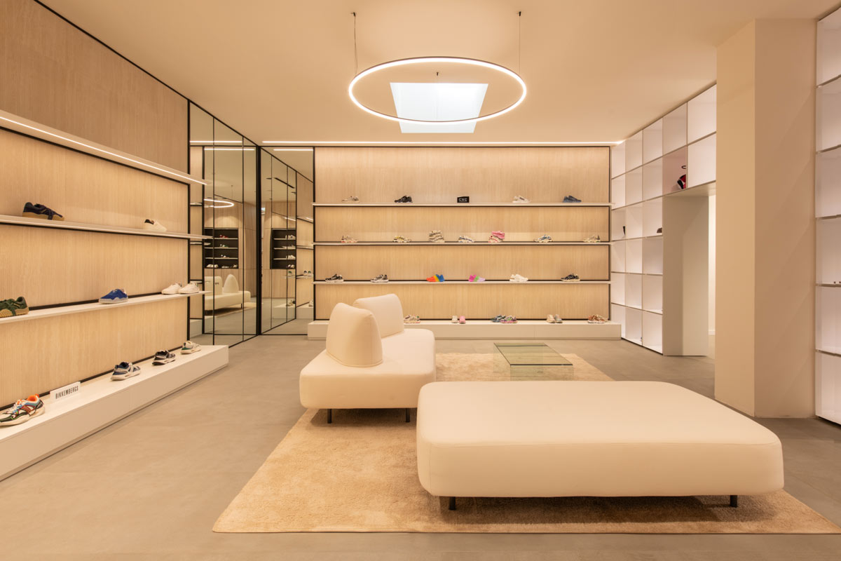Showroom D’Asdia a Palermo, zona lounge con arredi chiari, superfici in rovere e sistemi espositivi